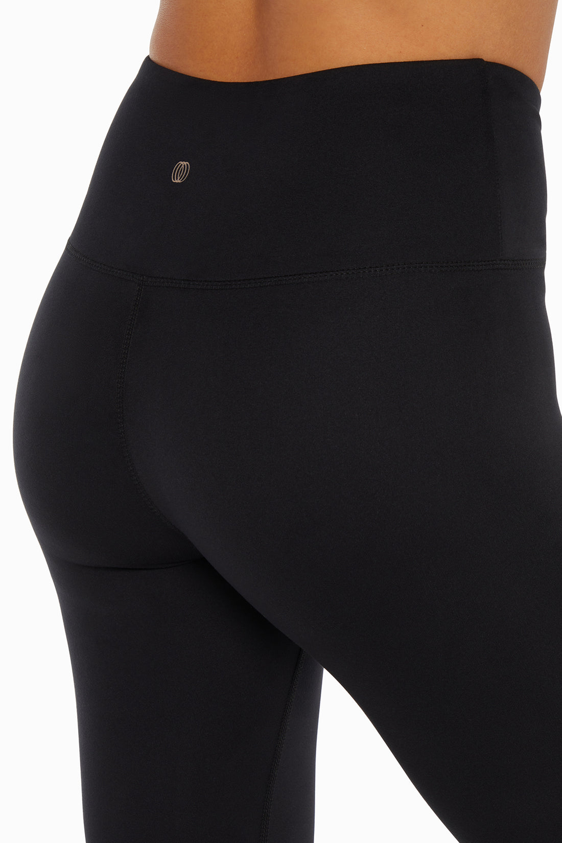 Balance Collection Crossover Legging, side view showing pocket placement, showing visible design features and texture of the stretch knit fabric..