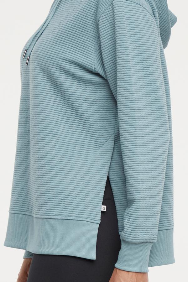 Cora Pullover Hoodie, alternate angle view, showing visible design features and texture of the soft fleece fabric..