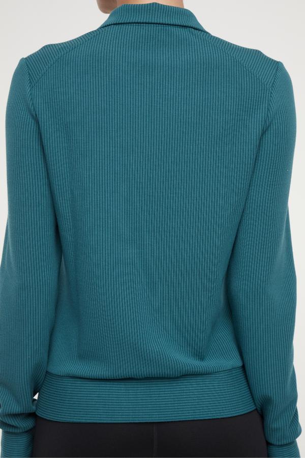 Paige Full Zip Jacket, side view showing pocket placement, showing visible design features and texture of the smooth woven fabric..