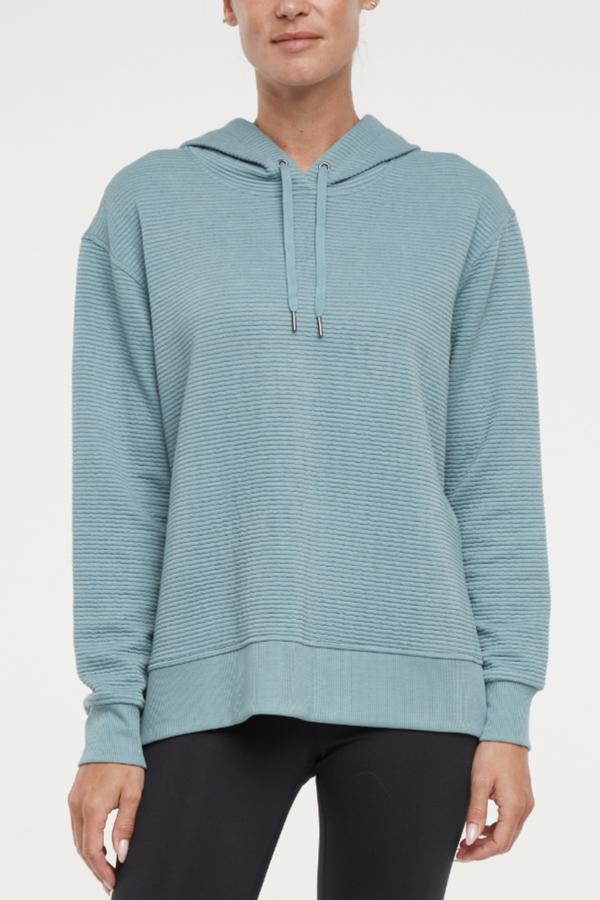 Cora Pullover Hoodie, alternate angle view, showing visible design features and texture of the soft fleece fabric..