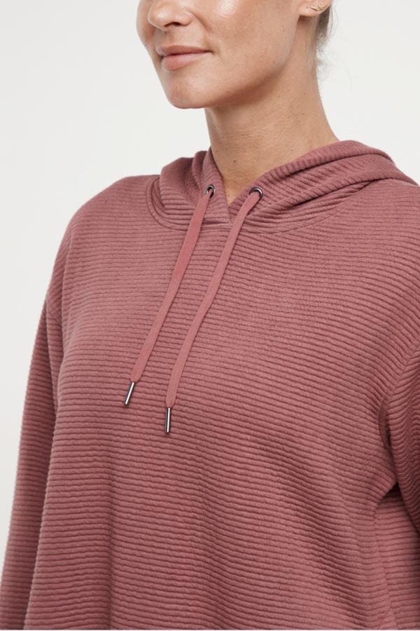 Cora Pullover Hoodie, alternate angle view, showing visible design features and texture of the soft fleece fabric..