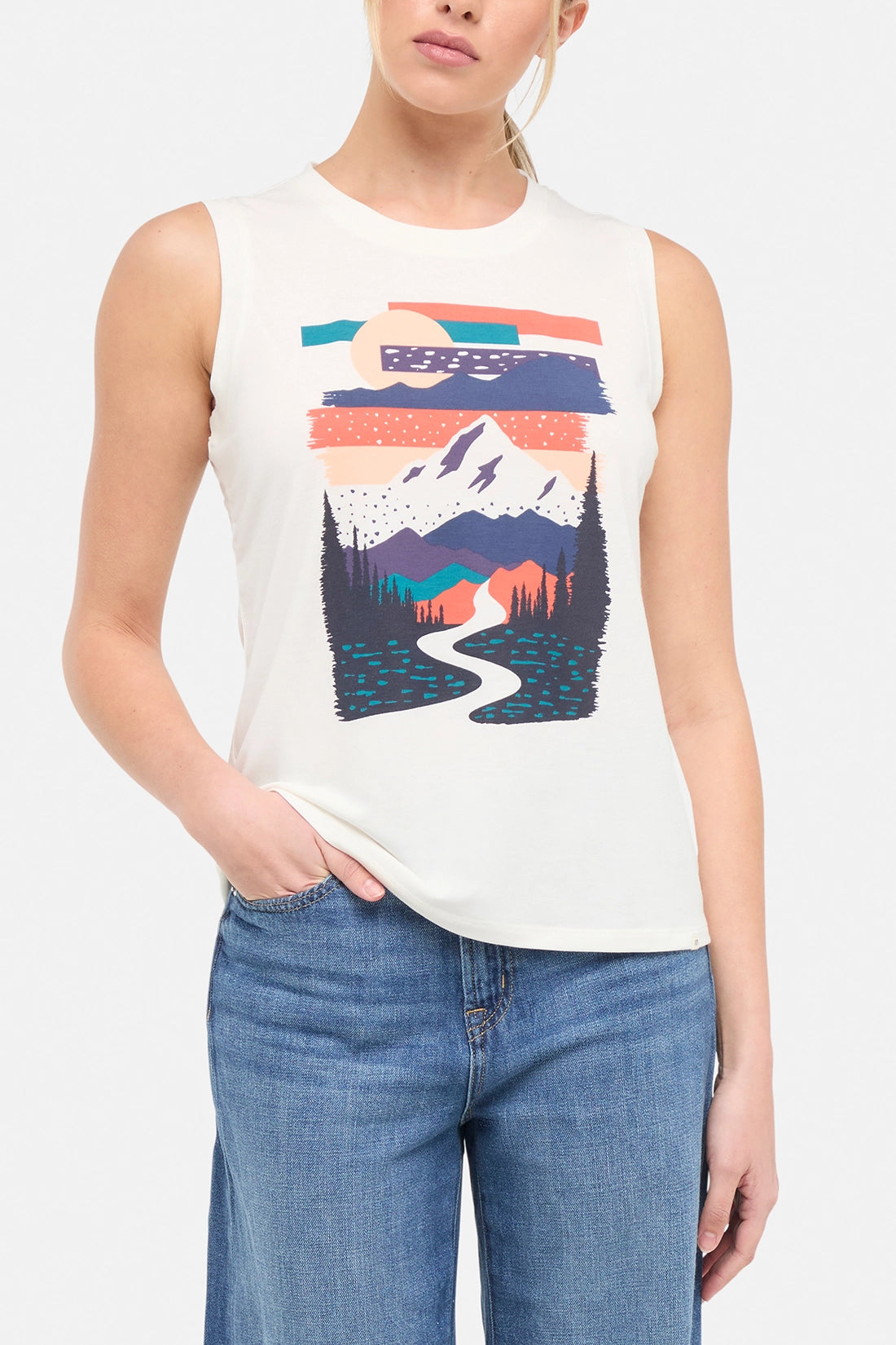 Front view of woman wearing a sleeveless shirt with a mountain graphic design on a plain background.