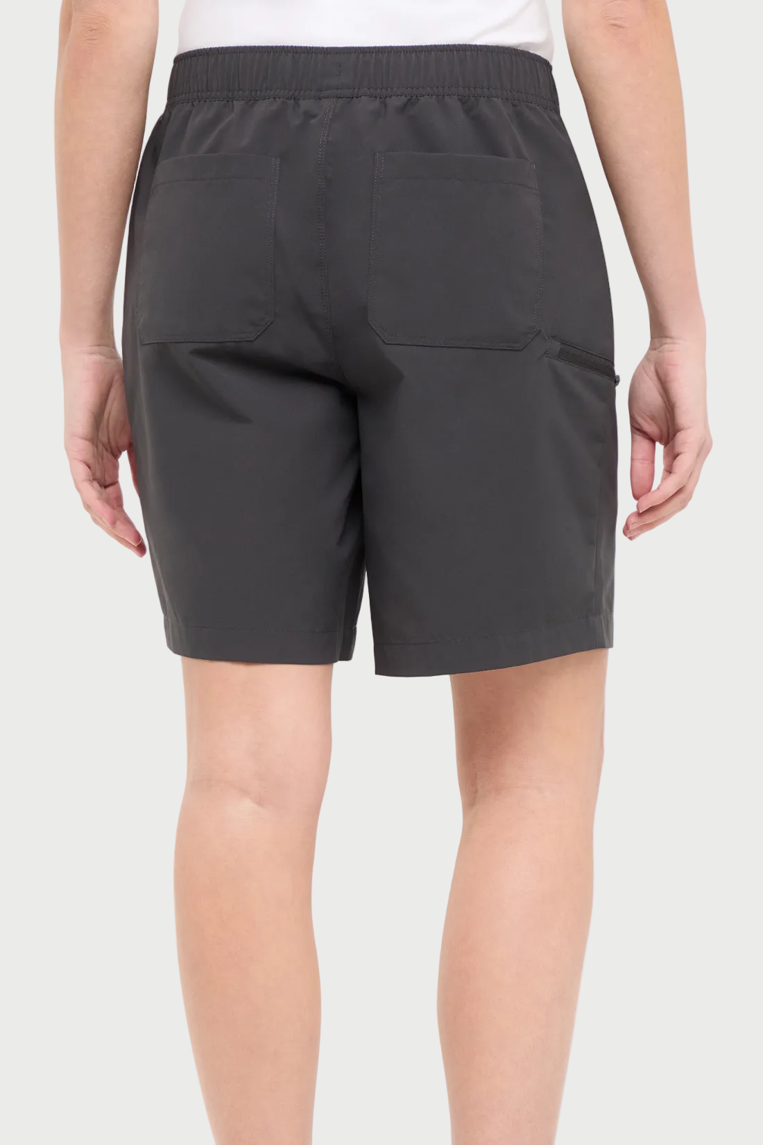Back view of woman wearing dark gray shorts with a white drawstring, standing on a white background.