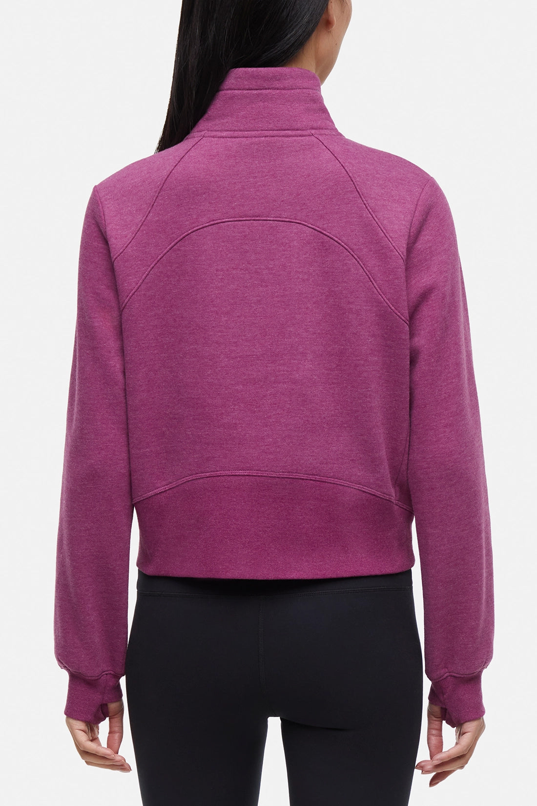 Back view of woman wearing burgundy half-zip pullover with thumbholes on a white background.