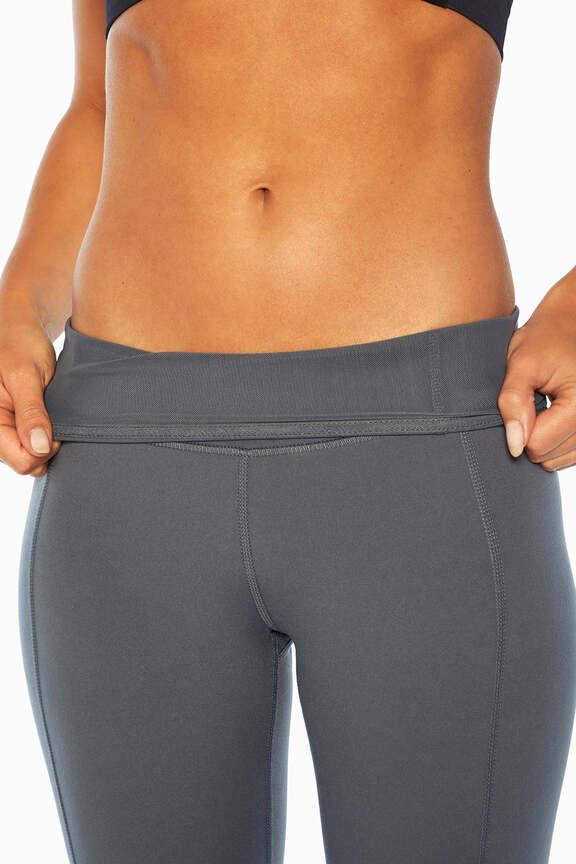 Olivia High Rise Tummy Control Legging - Turbulence, side view showing pocket placement, showing visible design features and texture of the stretch..