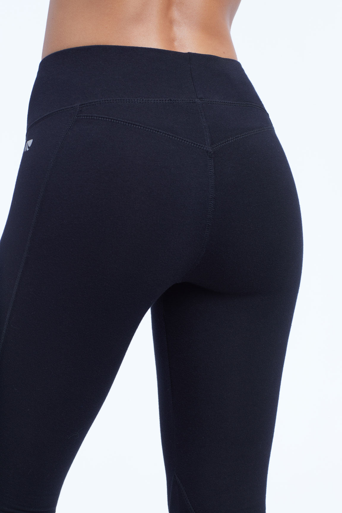 Camille Ultimate Slimming Leggings, side view showing pocket placement, showing visible design features and texture of the stretch knit fabric..