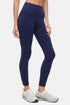 Side view of woman wearing navy leggings with a white background. 