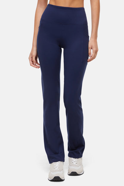 Navy blue leggings worn by a person on a white background. 