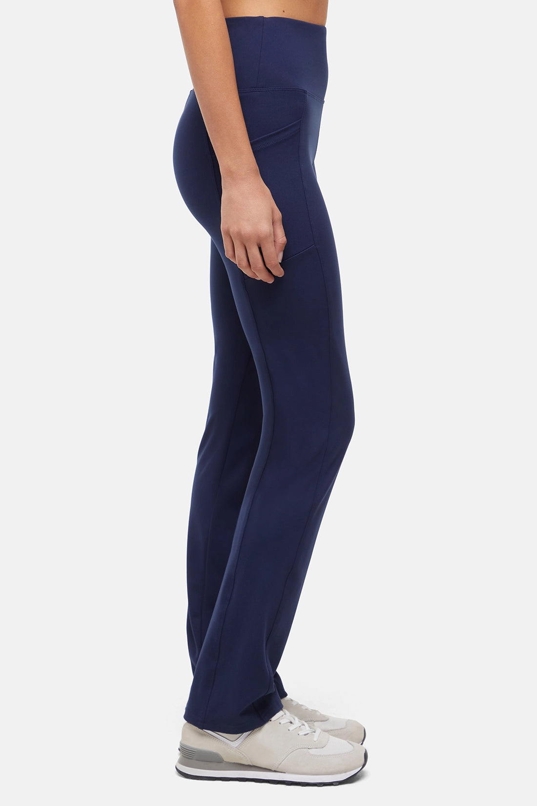 Navy blue leggings worn by a person on a white background. 