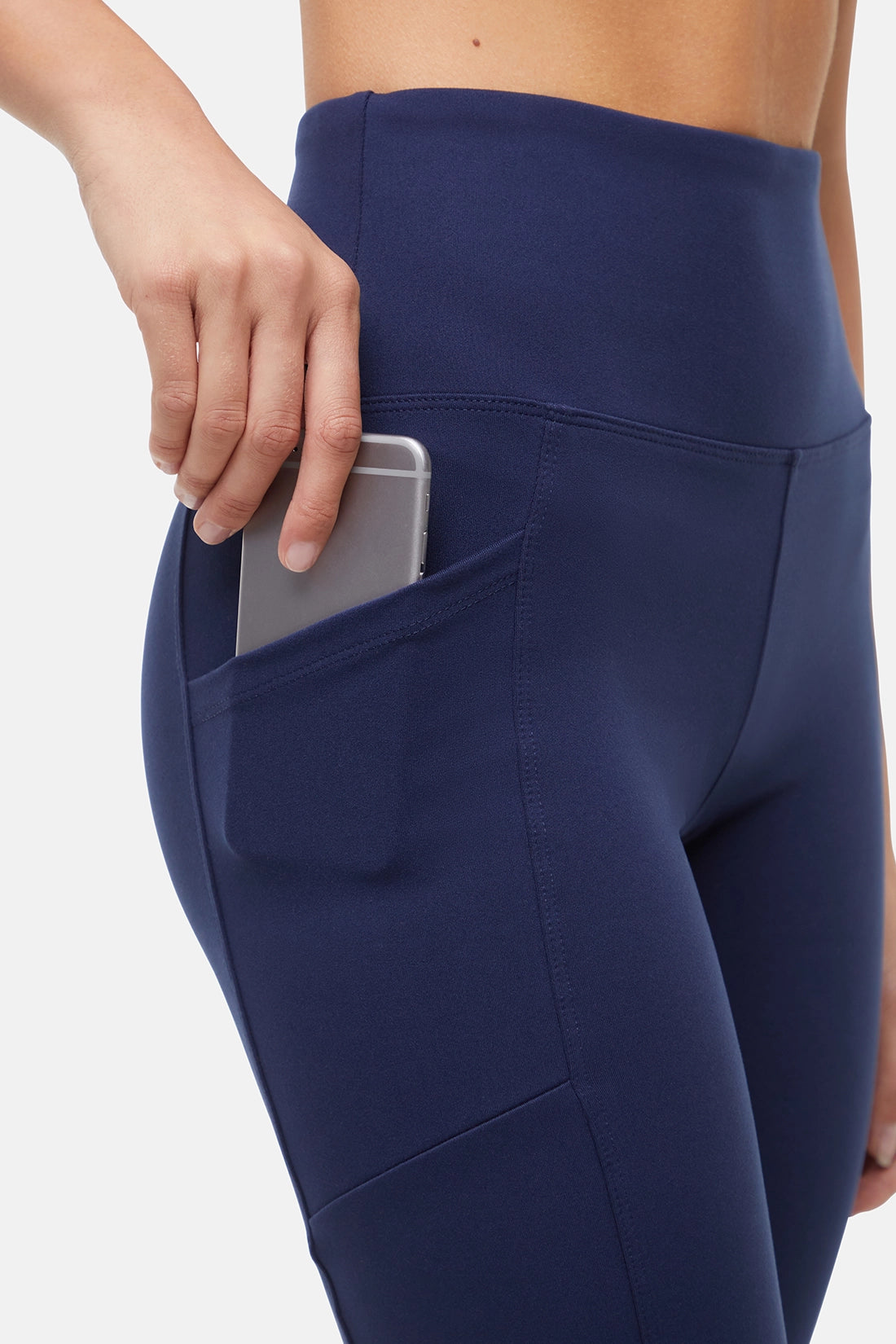 Navy blue leggings with a pocket on a white background. 