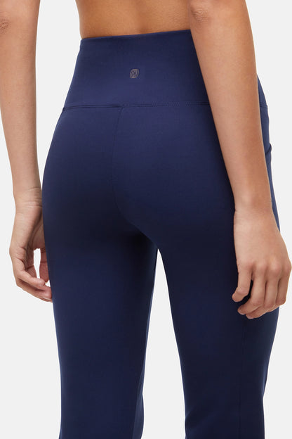 Navy blue leggings worn by a person on a white background. 