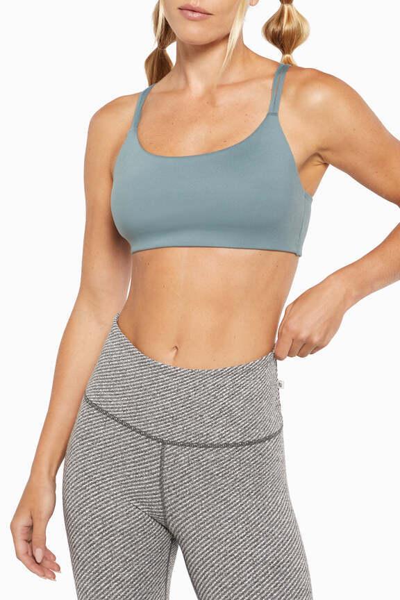 Camilla Sports Bra, close-up view of fabric and stitching, showing visible design features and texture of the soft knit fabric.. 