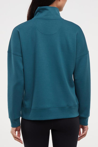 Sage 1/2 Zip, side view showing pocket placement, showing visible design features and texture of the soft knit fabric.. 