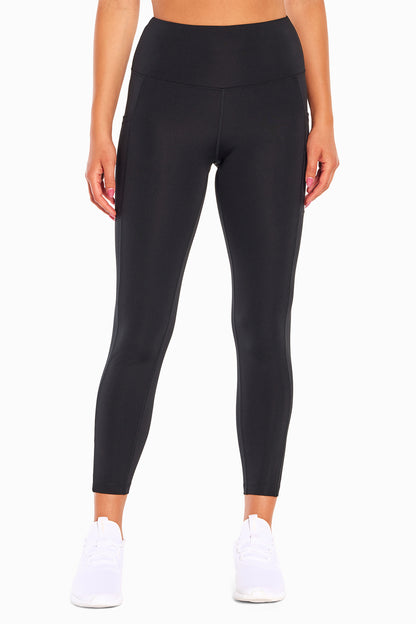 High Rise Side Pocket Ankle Legging - Black, alternate angle view, showing visible design features and texture of the stretch knit fabric.. 