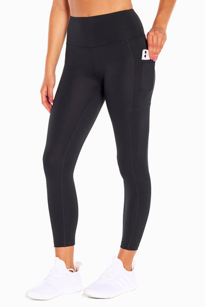 High Rise Side Pocket Ankle Legging - Black, front view, showing visible design features and texture of the stretch knit fabric.. 