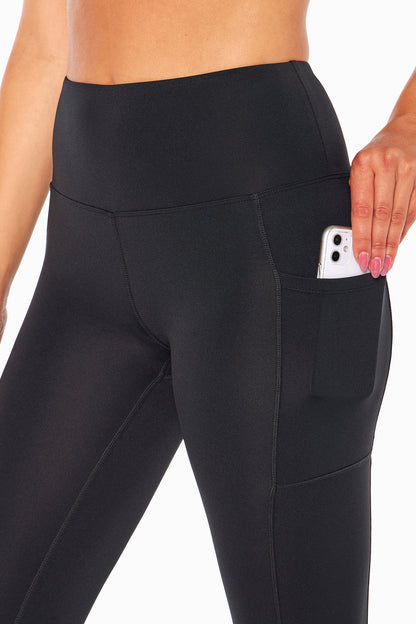High Rise Side Pocket Ankle Legging - Black, close-up view of fabric and stitching, showing visible design features and texture of the stretch knit.. 