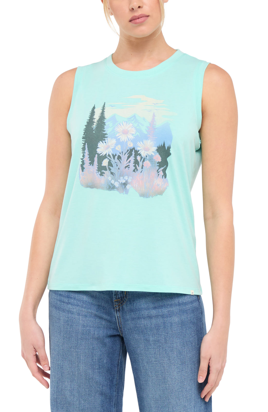 Front view of woman wearing a light teal blue sleeveless shirt with a trees and flowers nature graphic design on a white background.