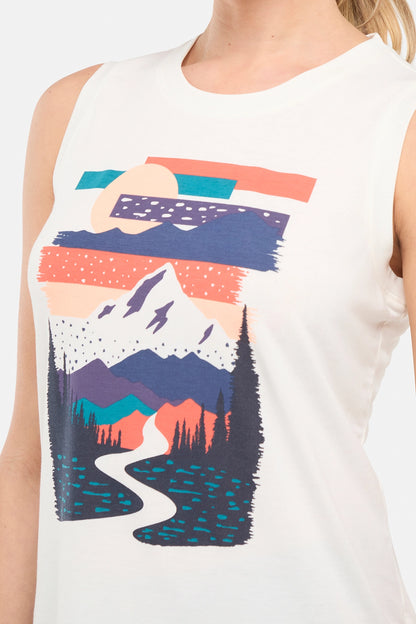 Close up front view of woman wearing a sleeveless shirt with a mountain graphic design on a plain background. 