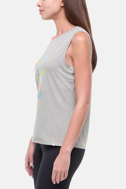Side view of woman wearing a sleeveless gray top with colorful floral and cactus design on a white background. 