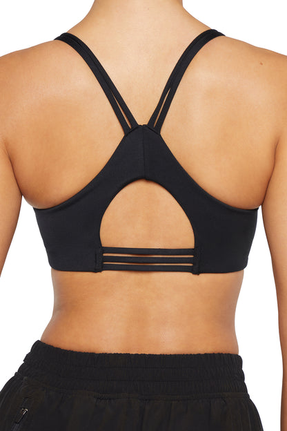 Camilla Sports Bra - Black, side view showing pocket placement, showing visible design features and texture of the soft knit fabric.. 