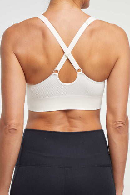 Addie Seamless Sports Bra, side view showing pocket placement, showing visible design features and texture of the soft knit fabric.. 
