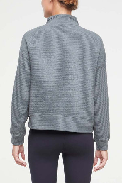 Freyi Pullover, side view showing pocket placement, showing visible design features and texture of the soft knit fabric.. 