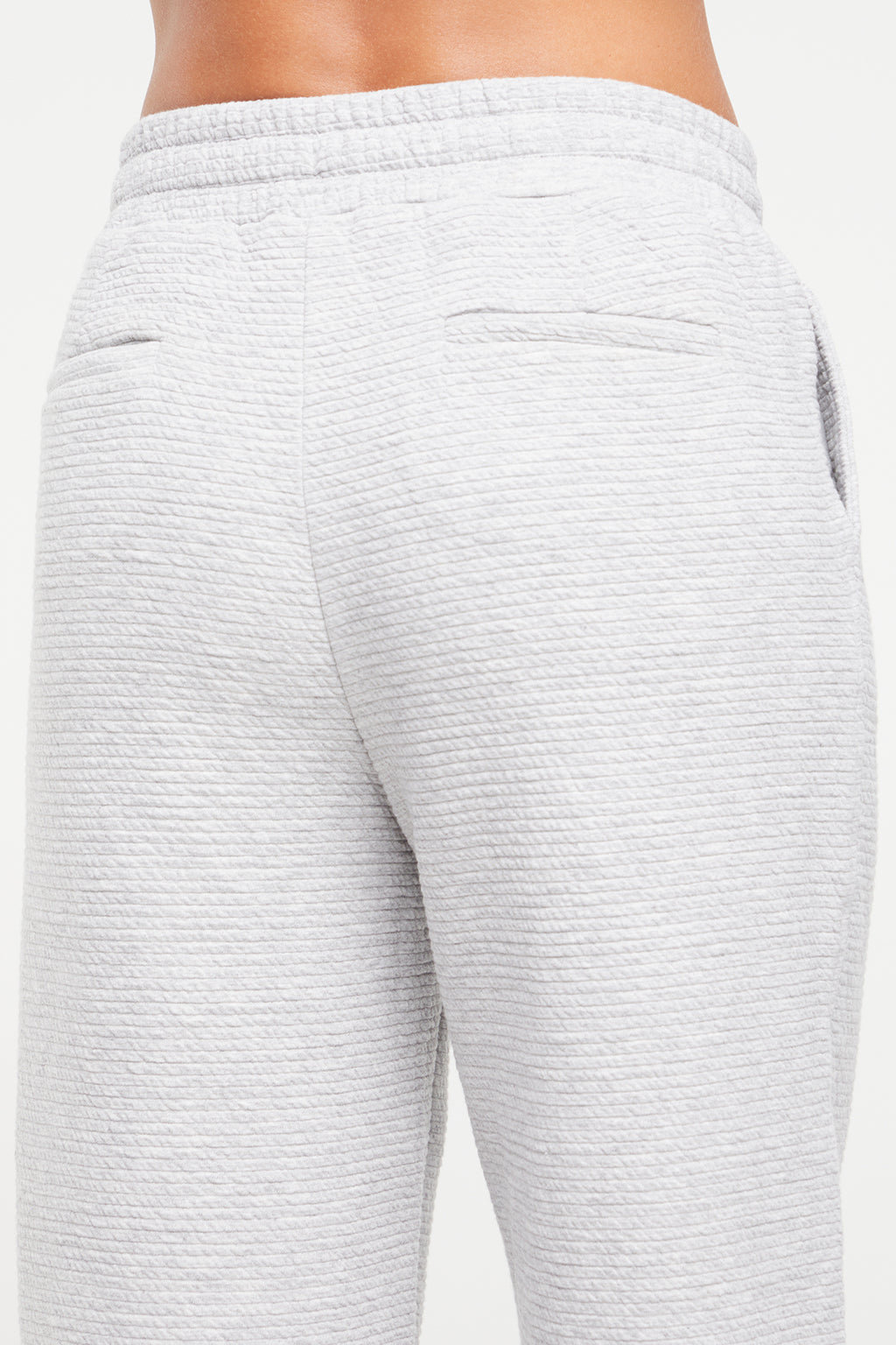 Freyi Pant, alternate angle view, showing visible design features and texture of the durable stretch fabric.. #color_heather-grey