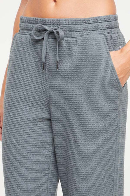 Freyi Pant, close-up view of fabric and stitching, showing visible design features and texture of the durable stretch fabric.. 