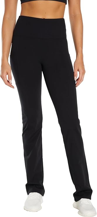 Front view of woman wearing black high-waisted pants on a white background. #color_black