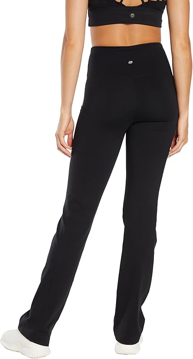 Back view of woman wearing black high-waisted pants on a white background. #color_black
