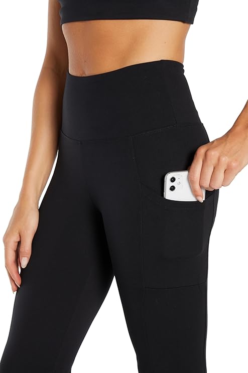 Close up front view of woman wearing black high-waisted pants on a white background. #color_black