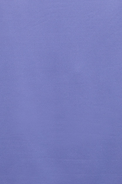 A close-up of a textured lavender-purple fabric surface. 