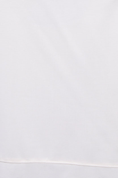 A close-up of a white ribbed knit fabric, showing the fine texture and a horizontal seam near the bottom edge.  