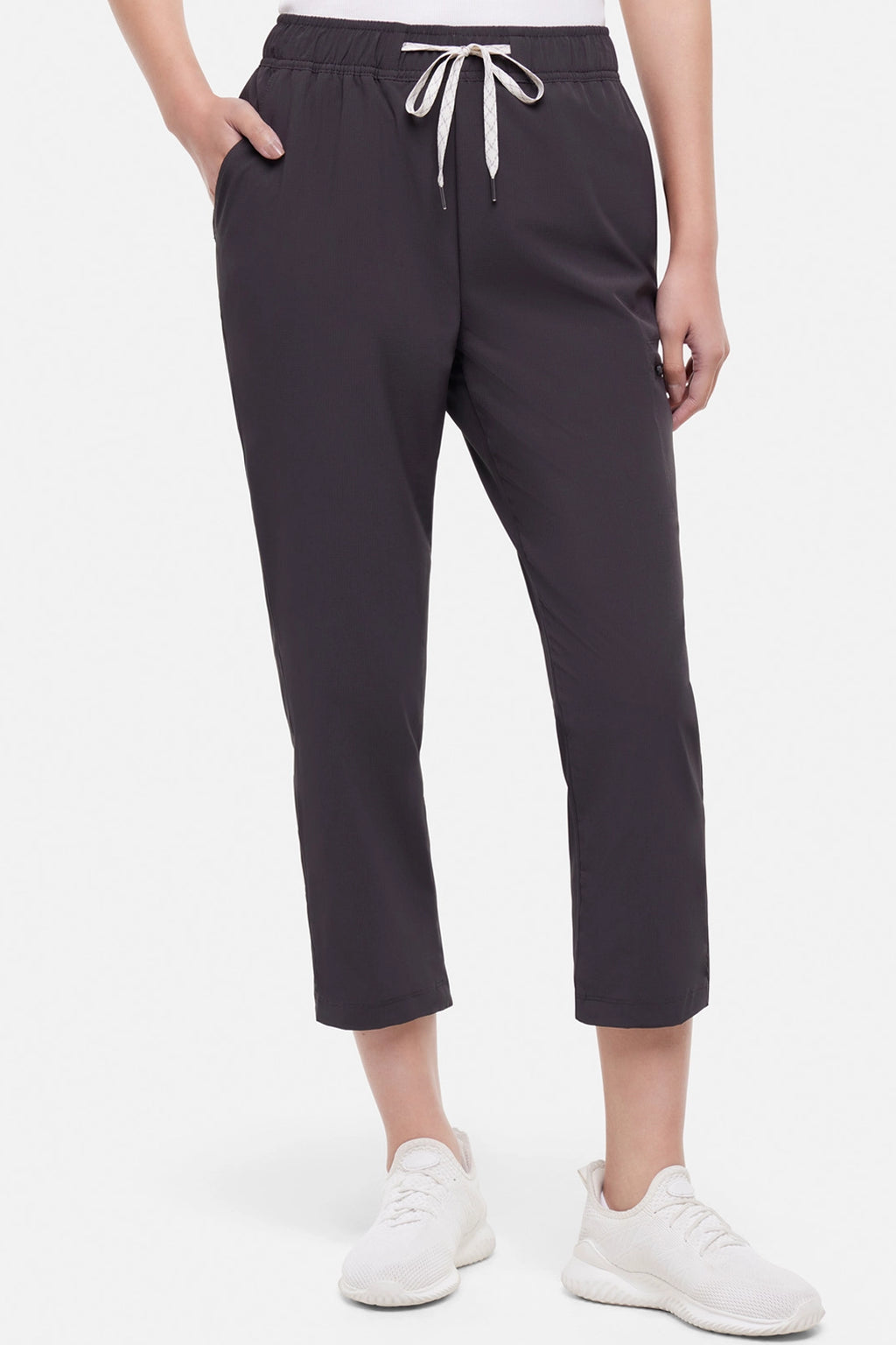 Front view of woman wearing black cropped pants with a white drawstring on a white background. #color_phantom