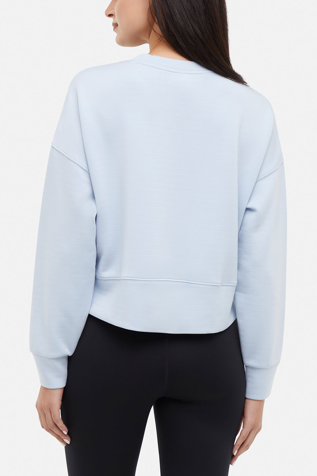 Becky Long Sleeve Crew Neck, side view showing pocket placement, showing visible design features and texture of the soft knit fabric.