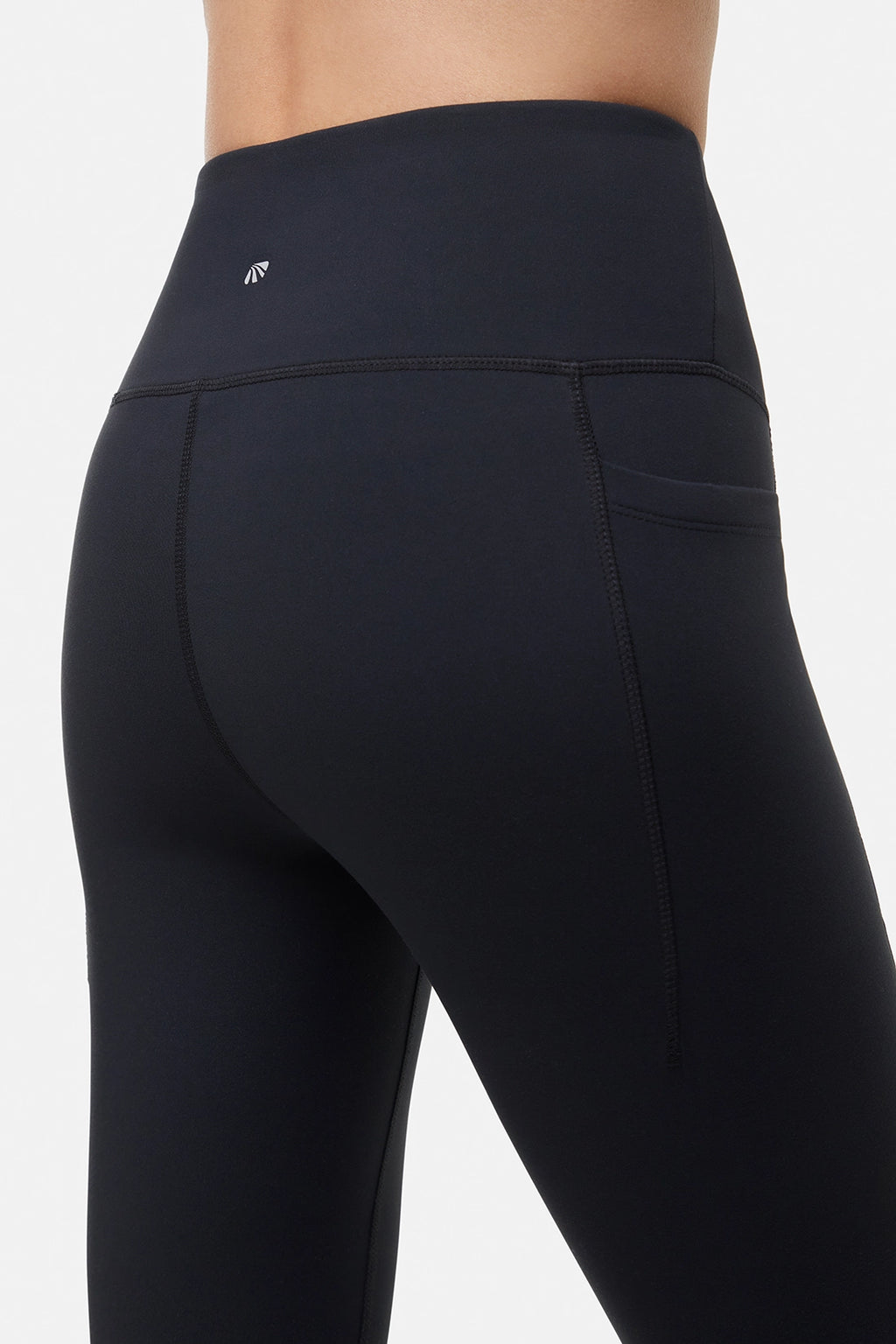 Back close up view of woman wearing black leggings worn by a person on a white background. #color_black