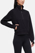 Front view of woman wearing black half-zip pullover with thumbholes on a white background. 
