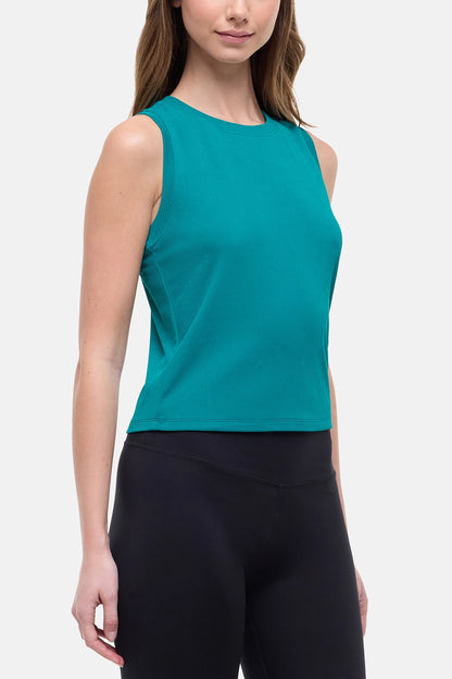 Front view of woman wearing a teal sleeveless top and black leggings on a white background. 