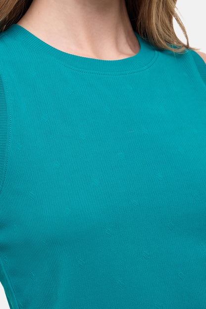 Close up front view of woman wearing a teal sleeveless top and black leggings on a white background. 