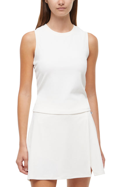 Front view of woman wearing a white sleeveless top and skirt set on a white background. 