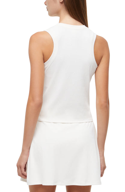 Back view of woman wearing a white sleeveless top and skirt set on a white background. 