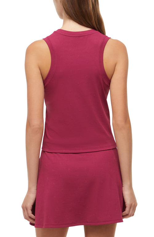 Back view of woman wearing a magenta sleeveless top and skirt set on a white background. #color_beaujolais