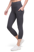 Front of woman wearing dark gray leggings with a white background. #color_forged-iron