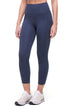 Front view of woman wearing navy blue leggings on a white background. 