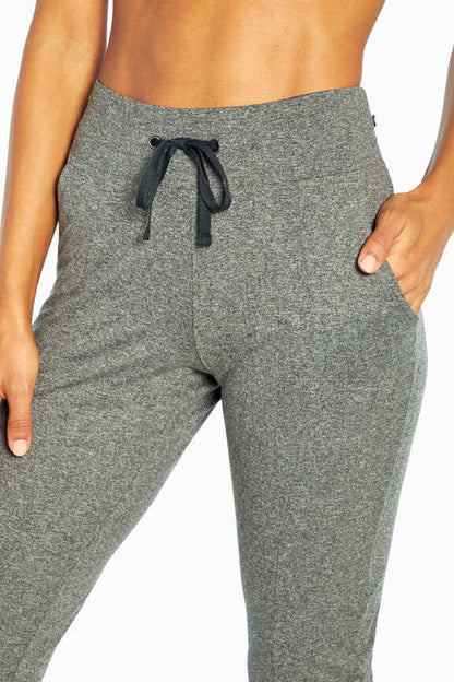 Mona Capri, close-up view of fabric and stitching, showing visible design features and texture of the soft knit fabric.. 