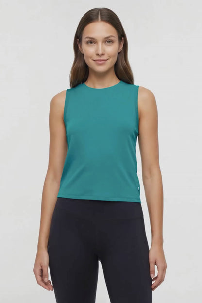 Video view of woman wearing a teal sleeveless top and black leggings on a white background. 