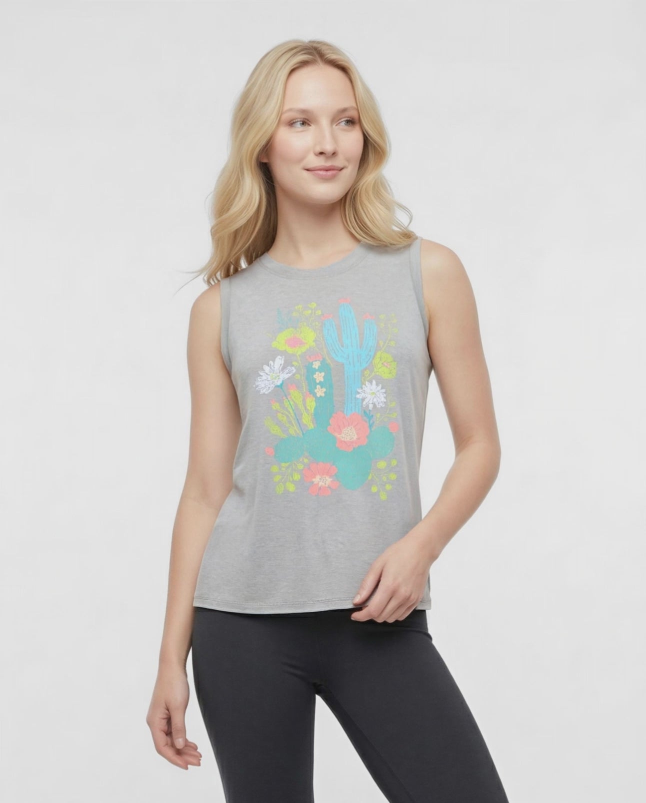 Video  view of woman wearing a sleeveless gray top with colorful floral and cactus design on a white background. #color_heather-shadow-distressed-floral-cactus