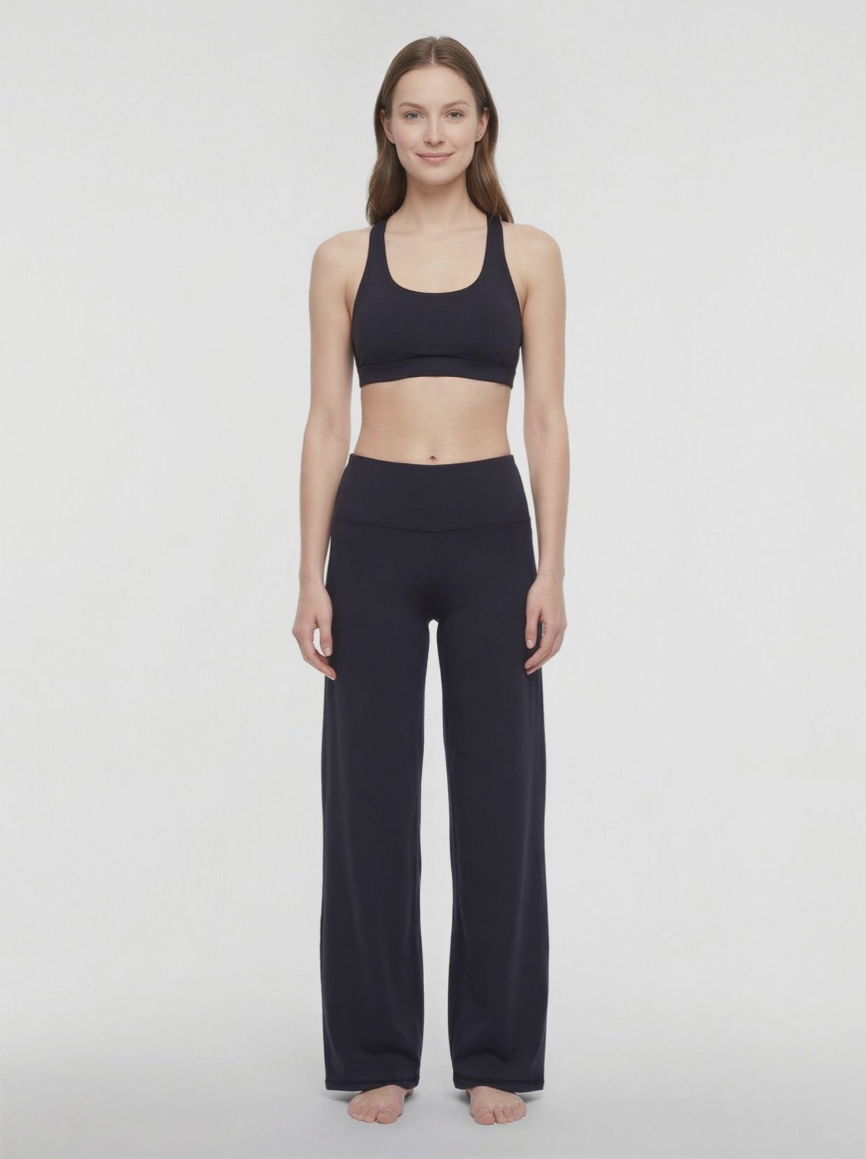 Video view of woman wearing black yoga pants on a white background. #color_black