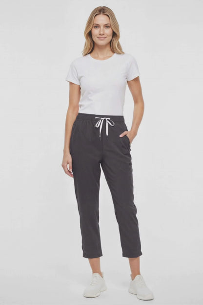 Video  view of woman wearing black cropped pants with a white drawstring on a white background. 