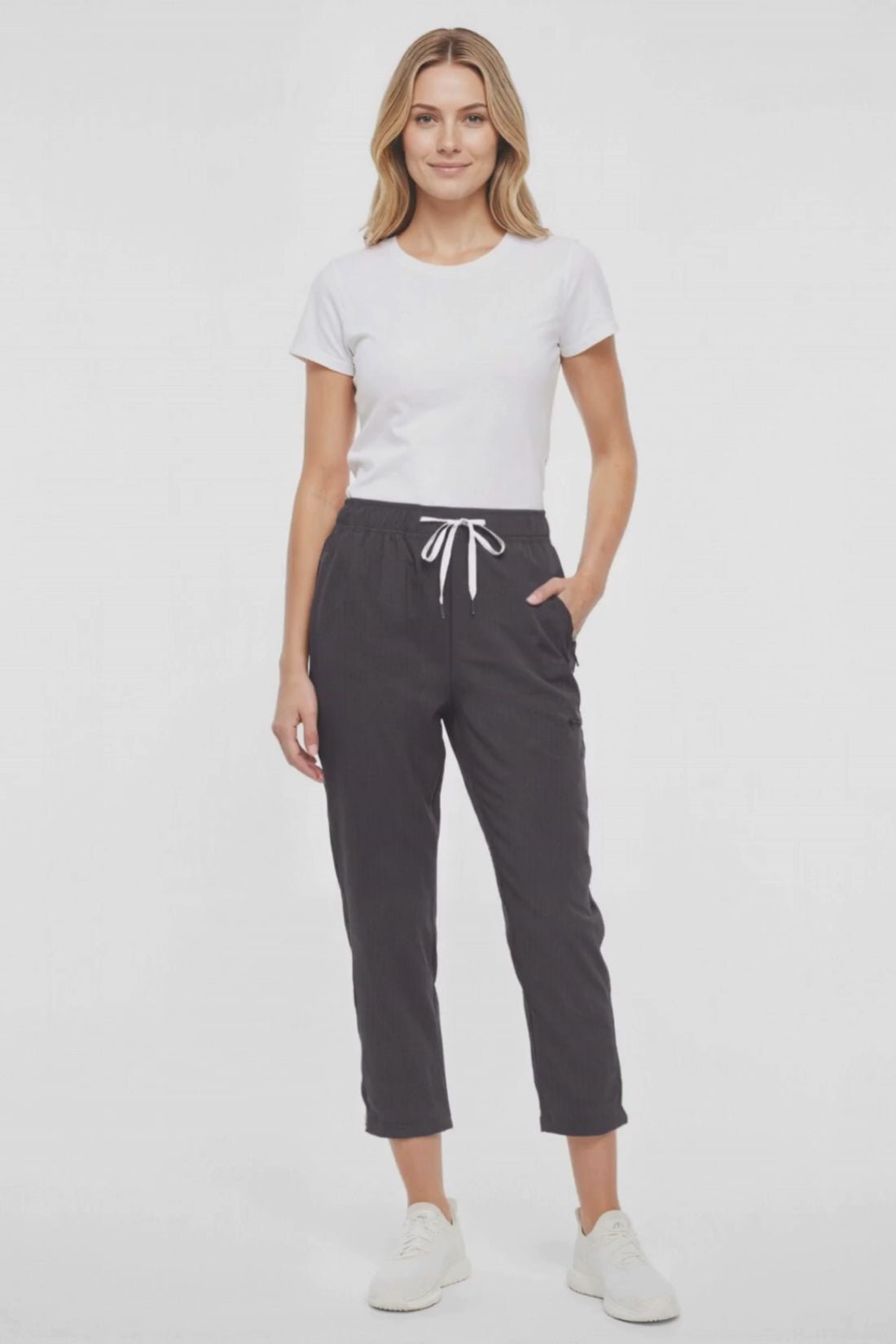 Video  view of woman wearing black cropped pants with a white drawstring on a white background. #color_phantom